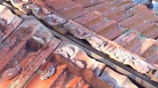 Leaking tile roofing repair  leaking ridge capping on a terracotta tile roof
