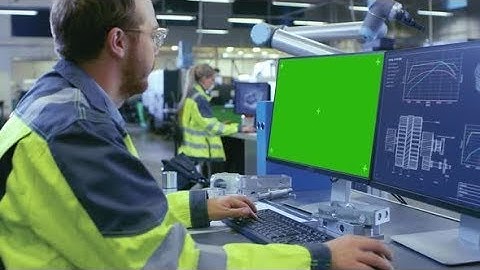 At the Factory: Mechanical Engineer Works on the Green Mock-up Screen Personal Computer | Stock