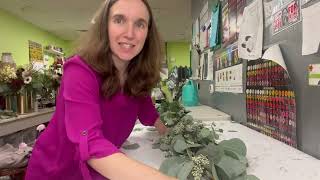 Florist shows how to make a simple eucalyptus garland with flowers for a wedding.