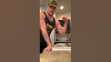Guy tries to crack an egg with his bicep, farts, and drops the egg.