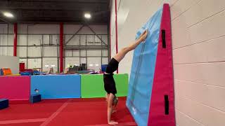Arched handstand against wall, snap feet down to front support