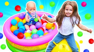Baby doll plays on a playground & in ball pit for kids. Kids entertainment. Family videos for kids.