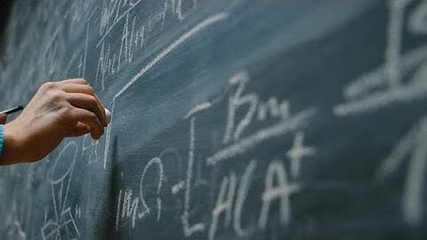 Hand Holding Chalk and Writing Complex and Sophisticated Mathematical Formula | Stock Footage -