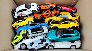 Box full of various miniature cars Peugeot, Jaguar, Pagani, Hyundai, Cadillac One, Opel, DHL 01