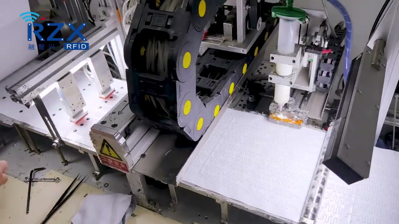 RFID laundry tag dispensing and attaching chip process