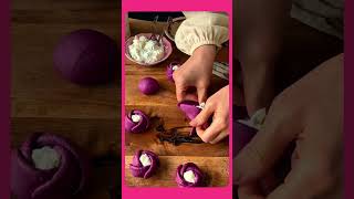 Bread dough flattened into rose-shaped petals, purple with a white center.