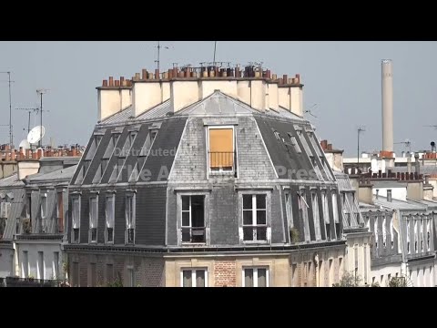 People living in attic apartments under zinc roofs of Paris suffer in the heat