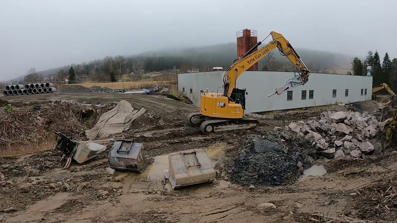 Caterpillar 335 excavator moving stone in Norway