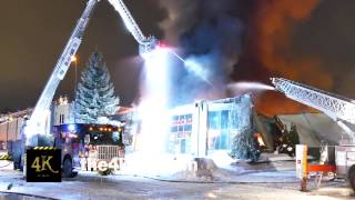 4K UHD - A soft focus view of ladder trucks spraying a large amount water screenshot 5