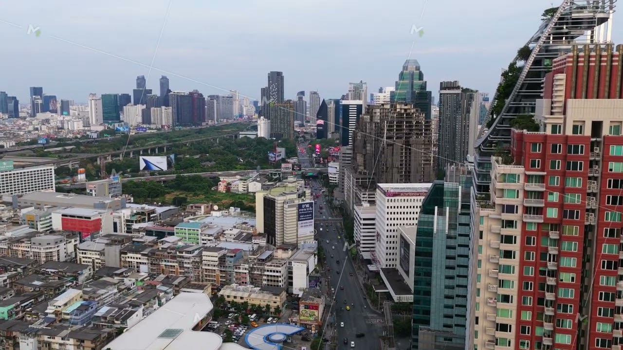 Bird's eye view showcasing Berkeley Hotel Pratunam and busy traffic flow on a major roadway slicing