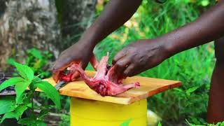 African Village Girl Slaughtering And Roasting Rabbit Near The River