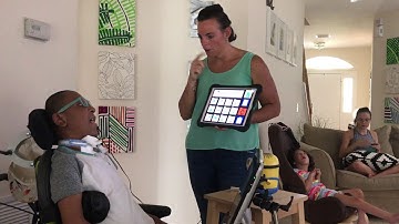 Mom modeling high tech PODD for Siah