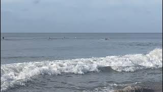 Surfers on Holden Beach back in August 21, 2025-08