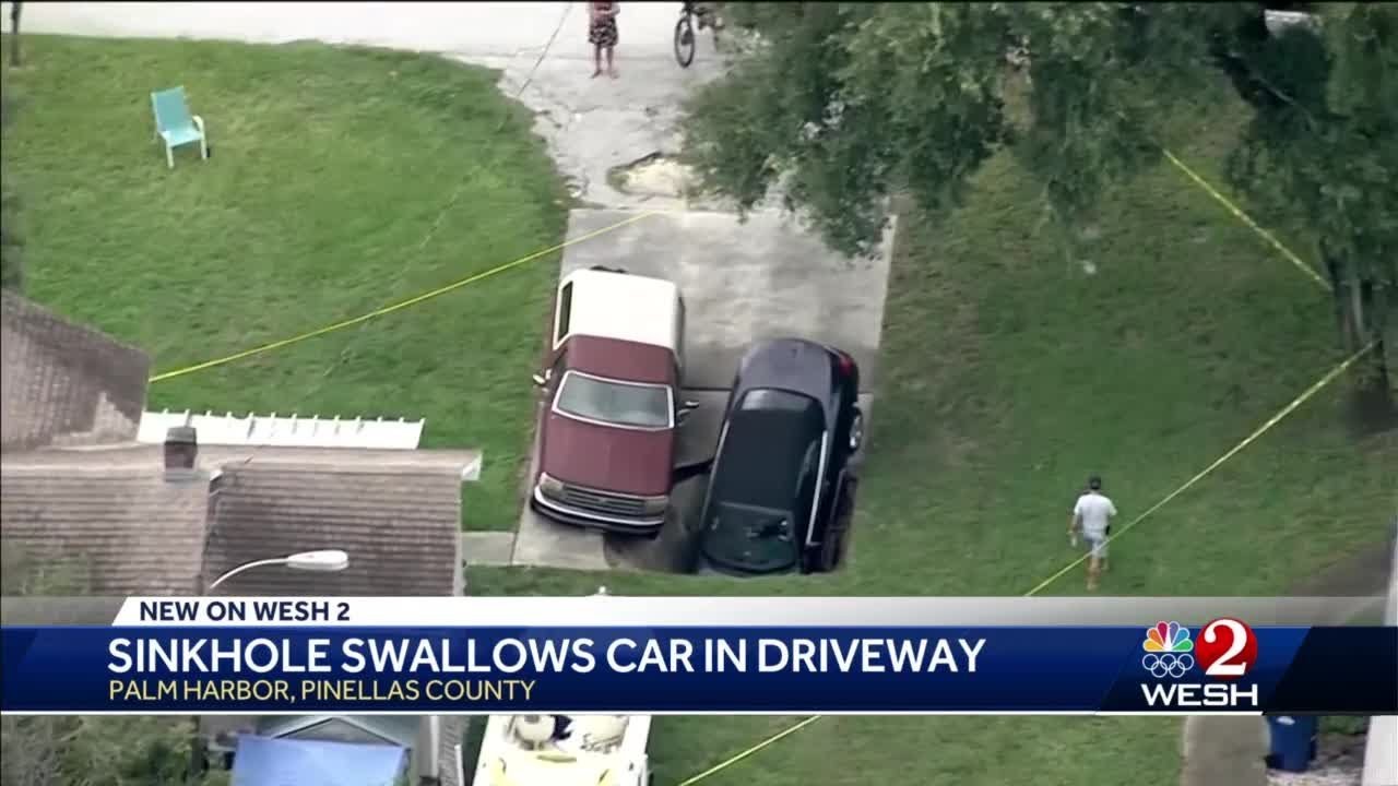 Sinkhole swallows car in Pinellas County driveway - YouTube