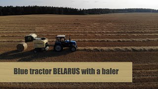 Driving a blue tractor BELARUS with a KRONE baler