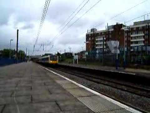 A Heathrow Connect Desiro slows for a red at Acton Main Line.