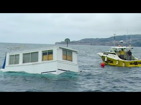 House Boat Sinks Beneath Waves of Water