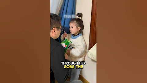 A father tries to comfort his crying daughter