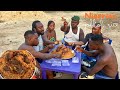 Eating of nigerian jollof rice fish sausage and chicken with oji