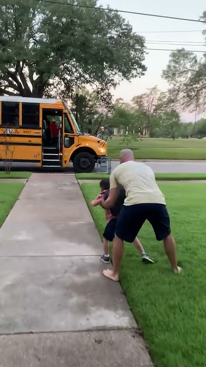 Little Boy Falls Onto Grass While Running to Catch School Bus - 1361653