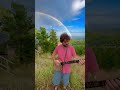 Playing banjo in front of the brightest rainbow ever! 🌈🪕