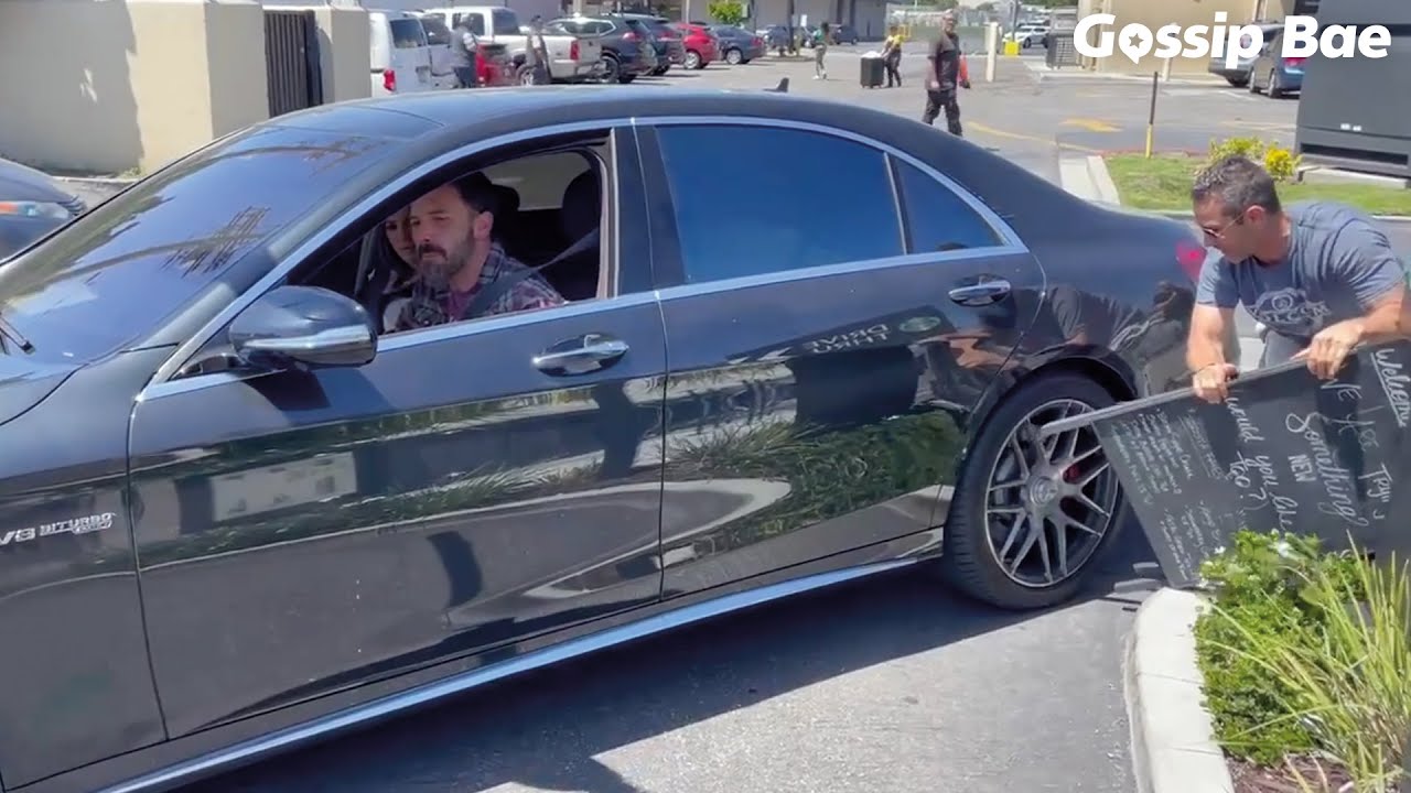 Ben Affleck & Jennifer Lopez get help from the paparazzi after running over a Starbucks sign