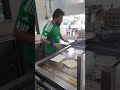 Prata master flipping and frying crispy roti parata