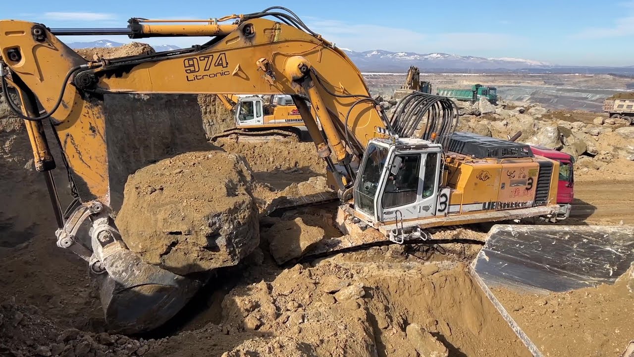 Liebherr 974 Excavator Loading Huge Rocks On Dumpers And Trucks With Soil - Ascon Ltd