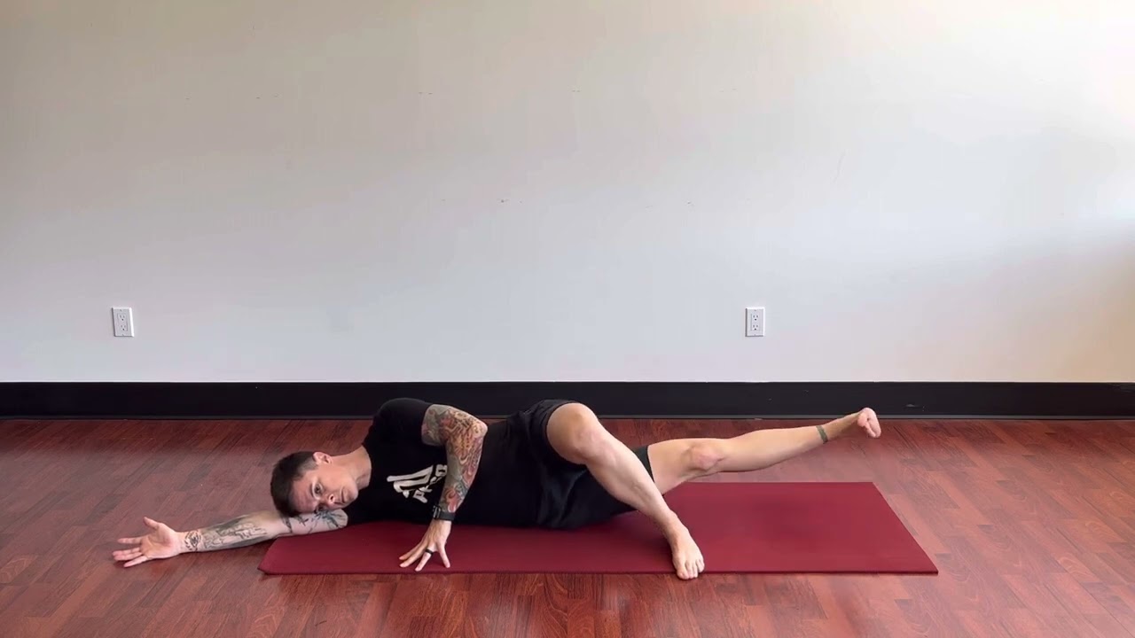 Person performing a side-lying adductor leg raise to strengthen inner thigh muscles and improve hip stability