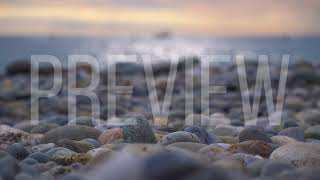 Rock Beach, Bokeh Sea and a Boat in the Distance