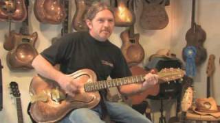 Doc Copper demonstrates one of his copper guitars