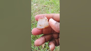 The color of this agate is white/pale white with reddish-brown or orange-red inclusions or stripes