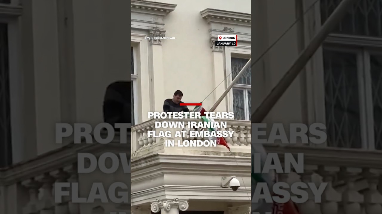 Protester tears down Iranian flag at embassy in London