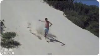Shirtless Sandboarder Takes A Spill