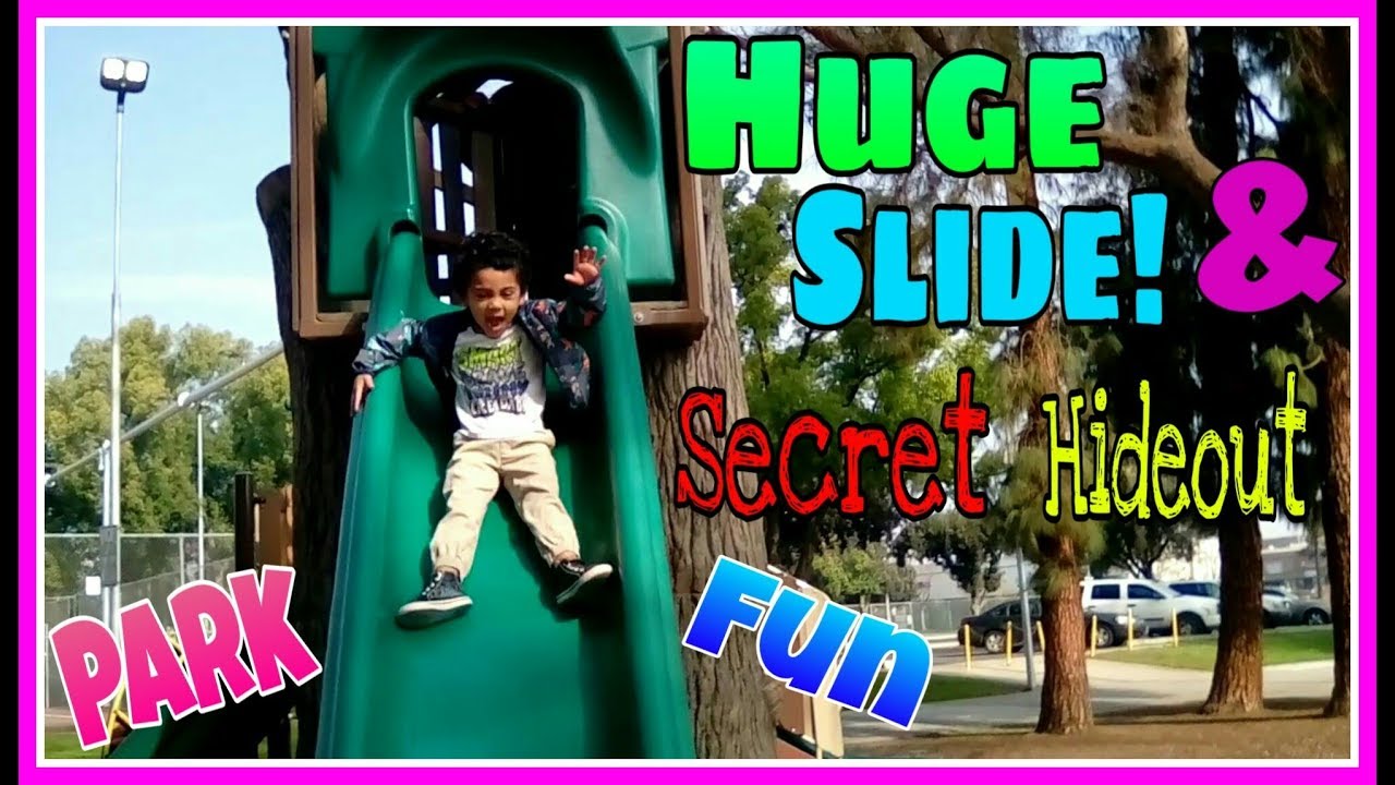 CHILDREN GO ON THE HUGE SLIDE AT THE OUTDOOR PLAYGROUND AND FAMILY HIDE ...