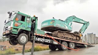 Moving Kobelco SK200 Excavator By Fuso Self Loader Truck