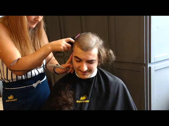 Beautiful barberette shaves heads of two boys class=