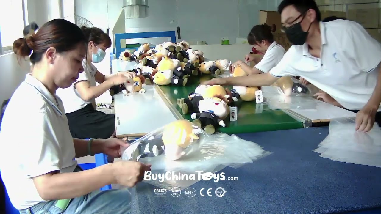 Workers packing finished stuffed animals into individual polybags for export
