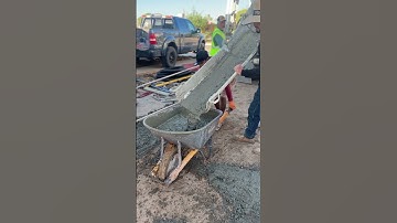 Construction worker using wheelbarrow to move cement!🏡💪 #construction #homedecor #landscaping