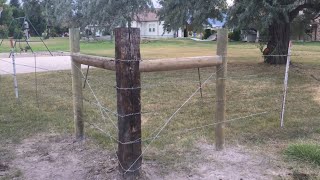 Installing new H brace corner barb wire fence for livestock.