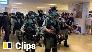 Riot police clear a shopping mall after ...