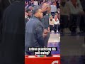 LeBron James practices his golf swing during the Suns vs Lakers game
