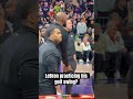 LeBron James practices his golf swing during the Suns vs Lakers game