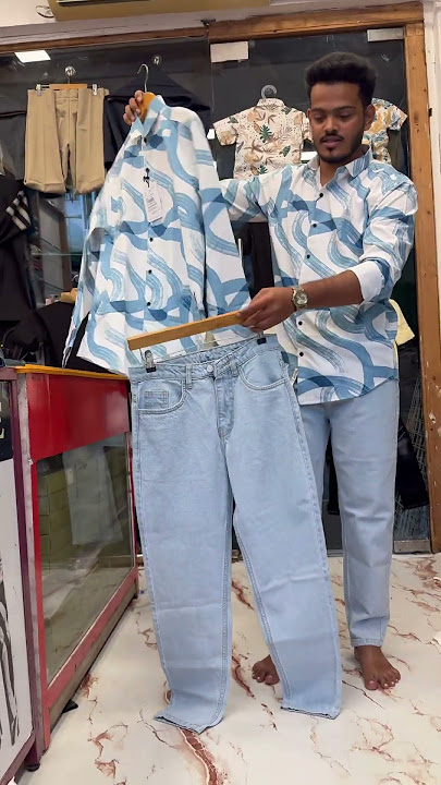 New look Shirt: White shirt with abstract light blue wavy design.Jeans: Light blue denim mom jeans