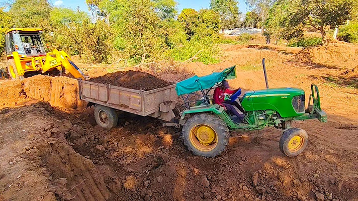 old jcb 3dx loading mud in trolly with single johndeer tractor
