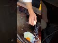 A medium-sized large pan is used to fry a large number of eggs