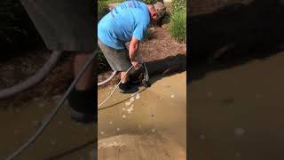 Using our “Sludge Sucker” to remove pooling water on driveway we pressure washed in Cochran, GA
