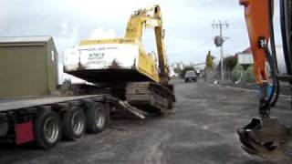 How not to unload an excavator.