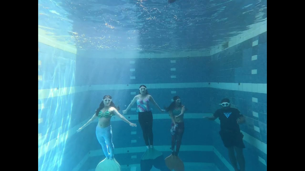 Mermaids while practicing neutral buoyancy. Breath holding and staying calm underwater