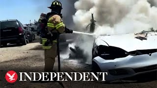 Tesla goes up in flames as firefighters struggle to extinguish battery